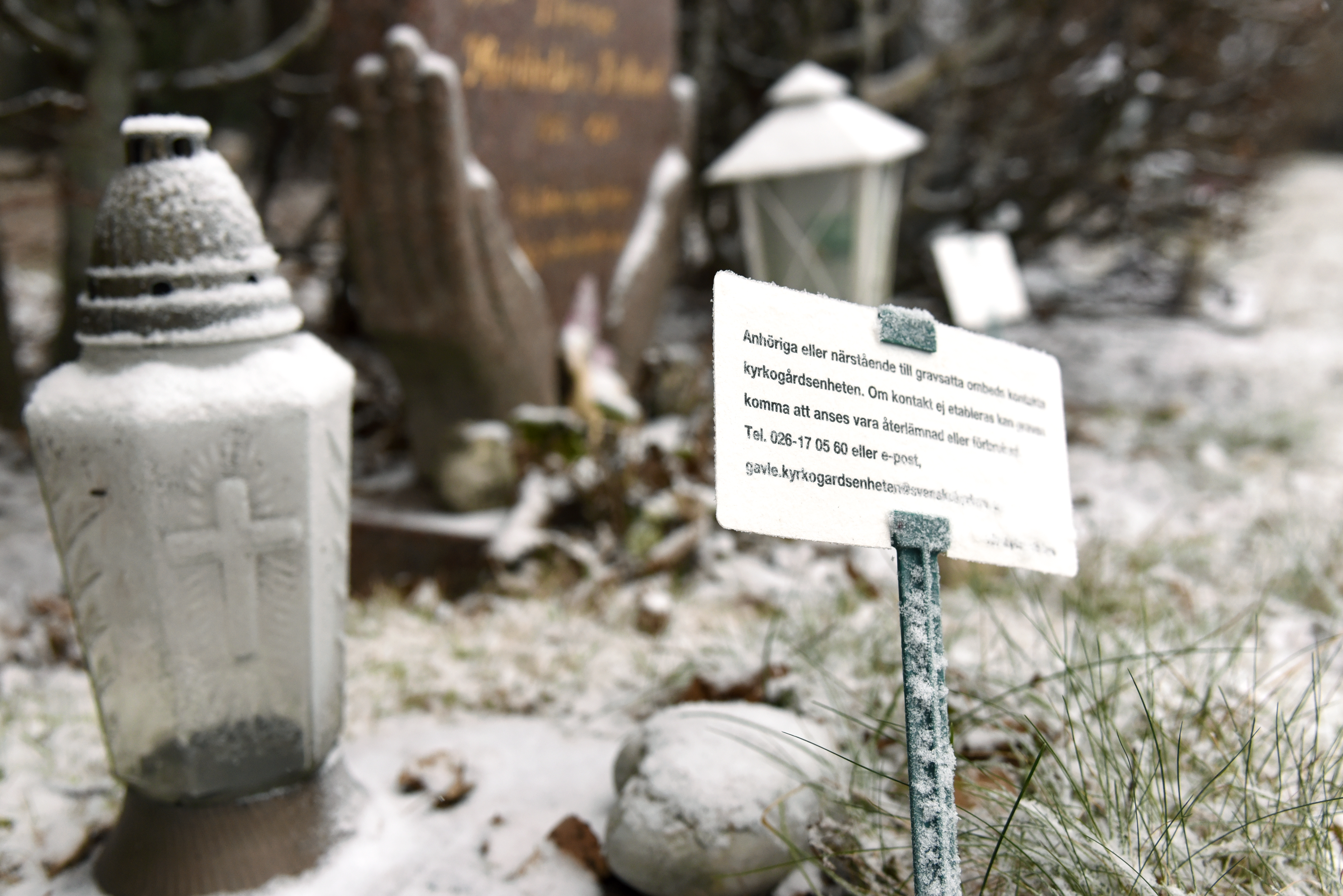 skylt på gravplats som uppmanar den som besöker graven att kontakta kyrkogårdsenheten