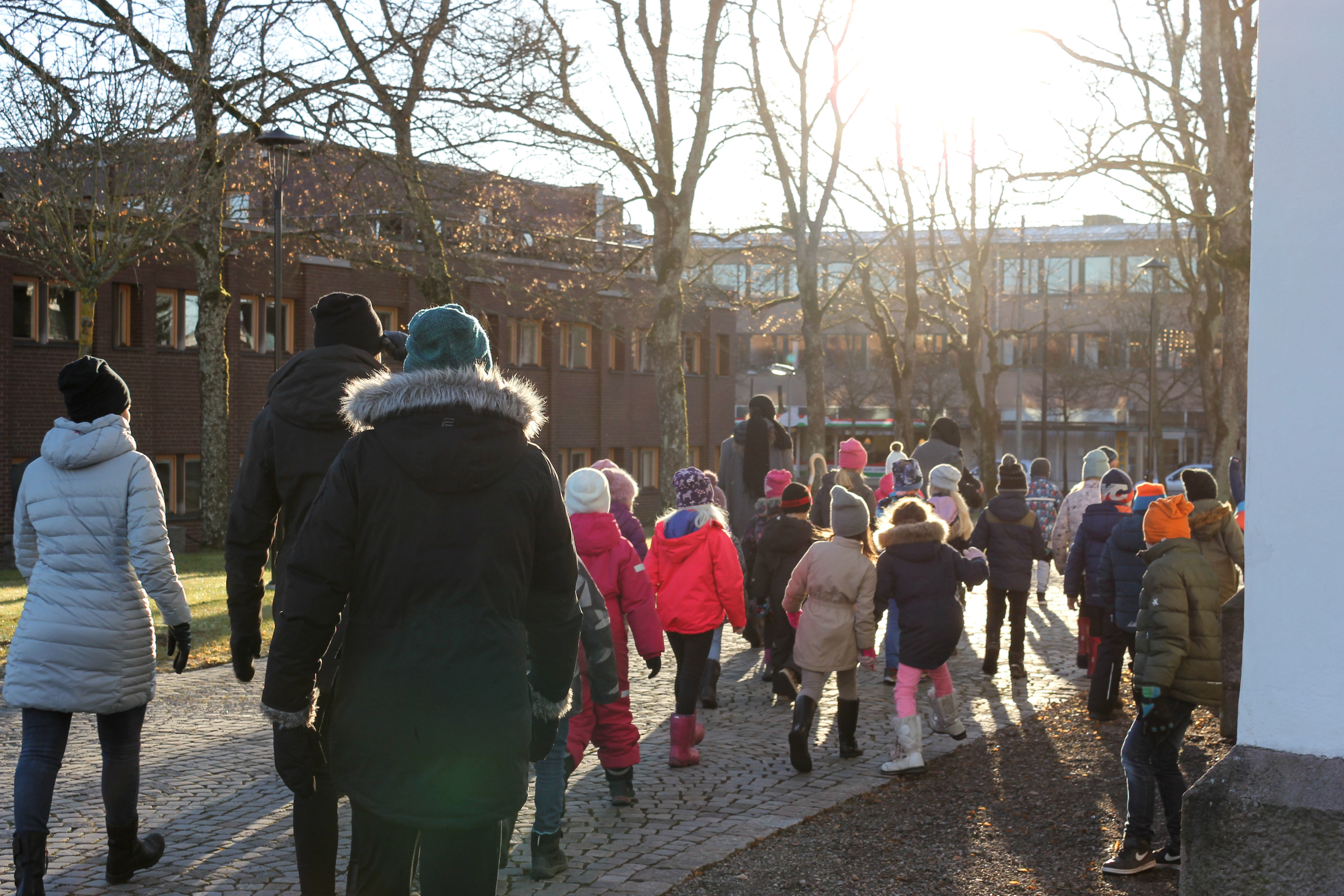 En grupp barn och några vuxna är ute och går en höstdag.